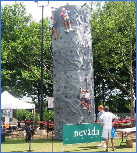 people using a portable rock climbing wall